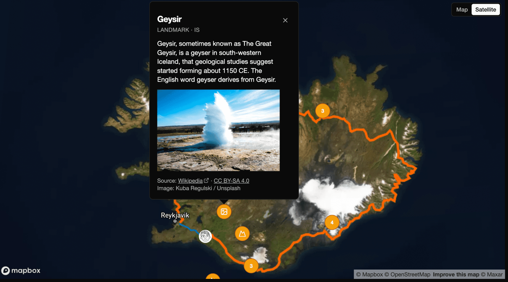 A satellite map of Iceland's Ring Road with a popup describing the Geysir hot spring, with a photo.